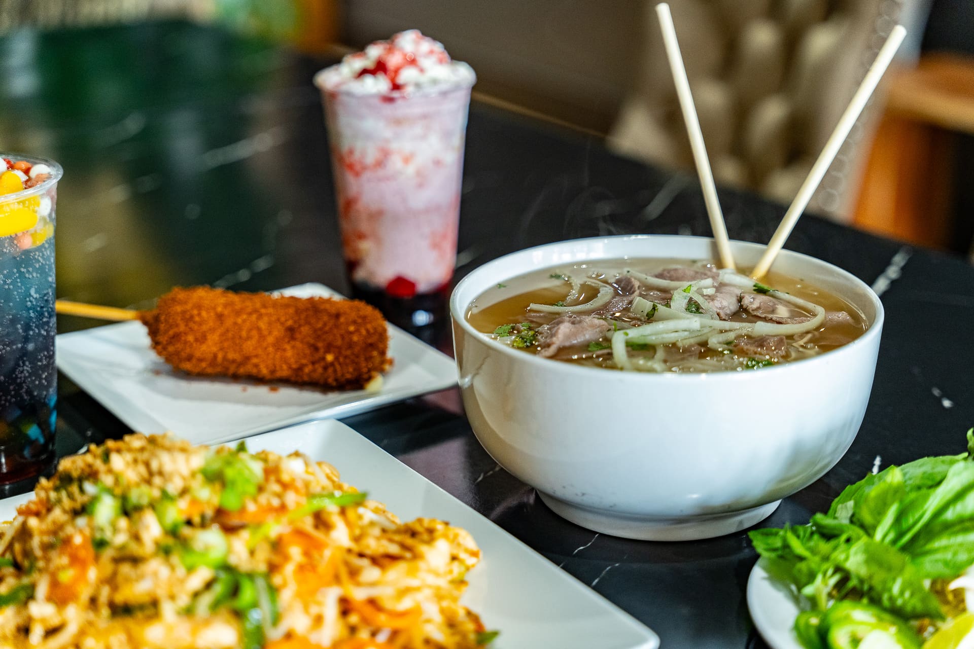 Phở, Pad Thai, Korean corn dog and drinks — a spread at Why Not My Asian Kitchen